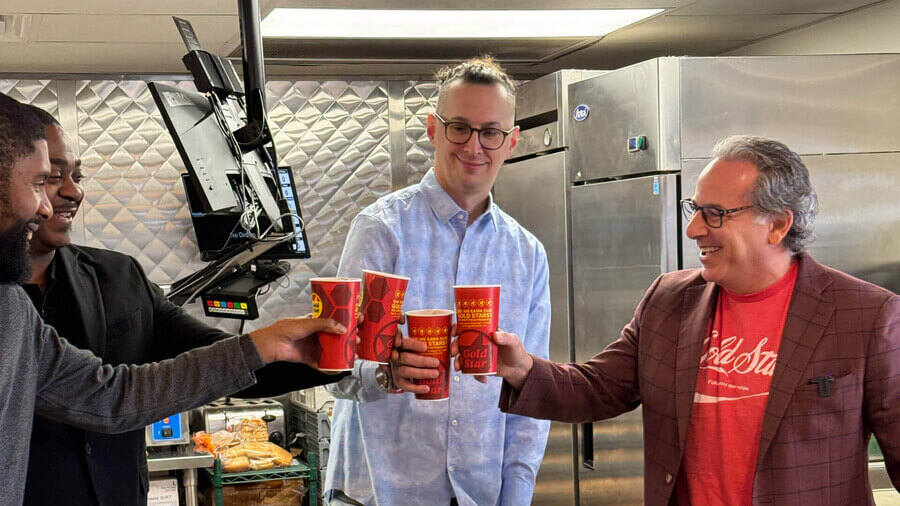 Four men toasting with fountain cokes