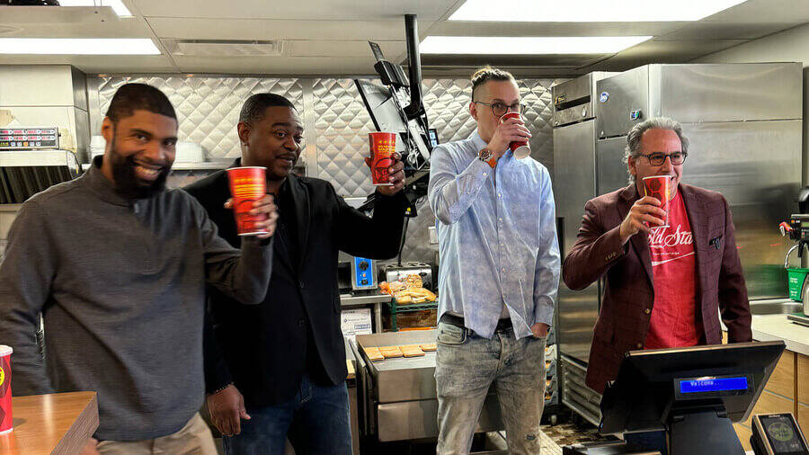 Four men drinking fountain cokes