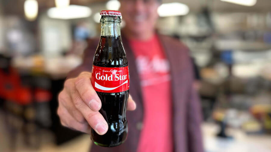 Man holding a bottle of coke