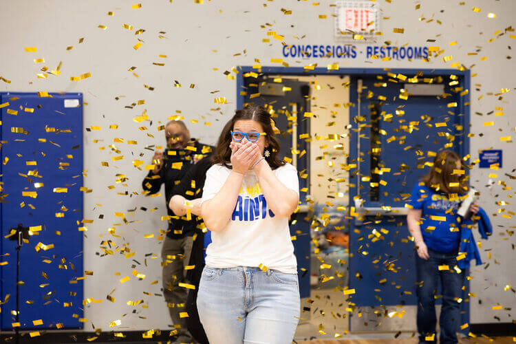 excited teacher entering a gymnasium