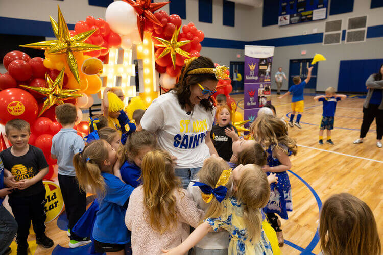 Children surrounding a teacher